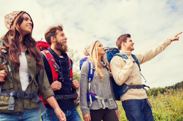 group of smiling friends with backpacks hiking - Fotoğraf, Görsel