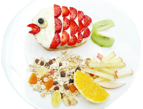 creative breakfast with fruit and sweet chocolate creme on bread - Photo, Image