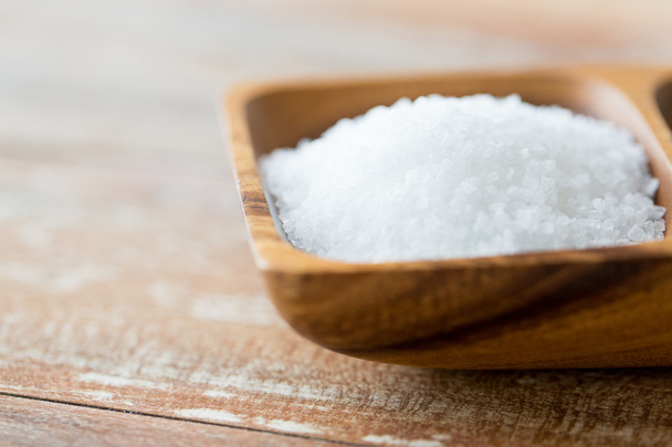 close up of white salt heap in wooden bowl - Foto, Imagem