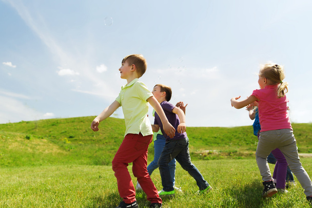 group of happy kids running outdoors - Foto, Imagen
