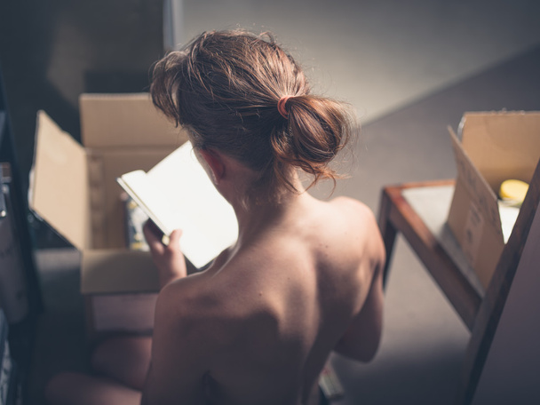 Topless woman packing a box - Foto, Imagem
