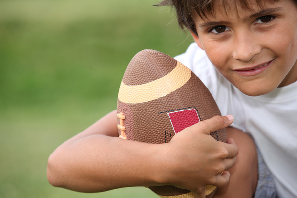 Young boy playing rugby - Valokuva, kuva