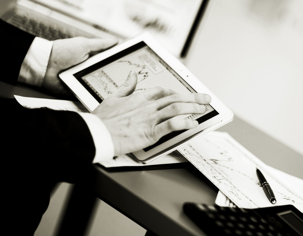 Businessman with finger touching screen of a digital tablet - Фото, зображення