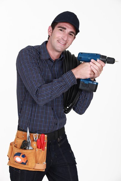 A handyman with a drill. - Foto, afbeelding