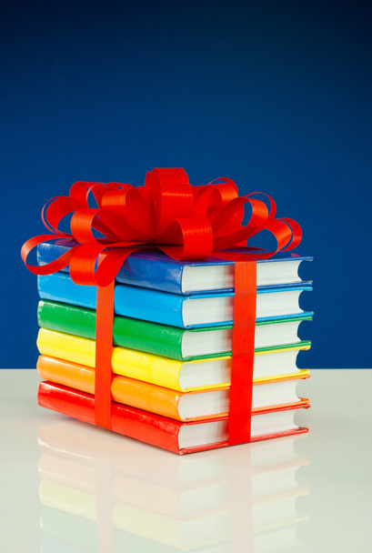 Stack of colorful books tied up with red ribbon - Photo, Image