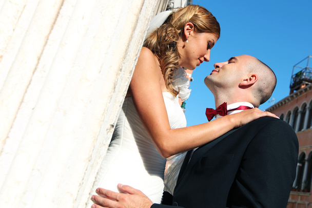 Bride and groom kissing in front of church - Photo, Image