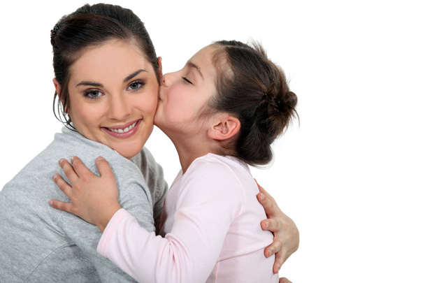 Daughter kissing her mum - Фото, зображення