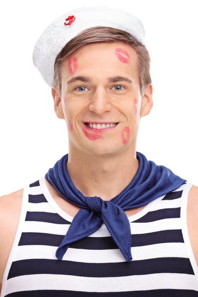 sailor covered in lipstick kiss marks - Foto, afbeelding