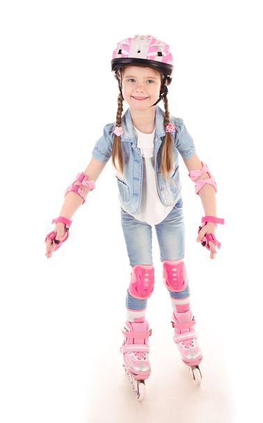 Cute smiling little girl in pink roller skates - Zdjęcie, obraz