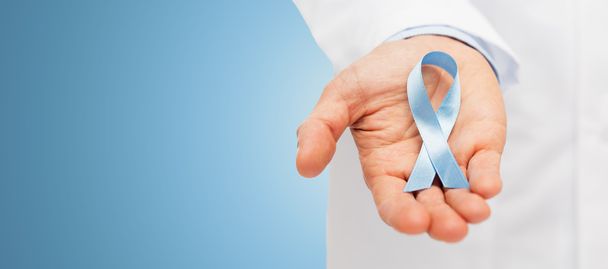 doctor hand with prostate cancer awareness ribbon - Фото, изображение