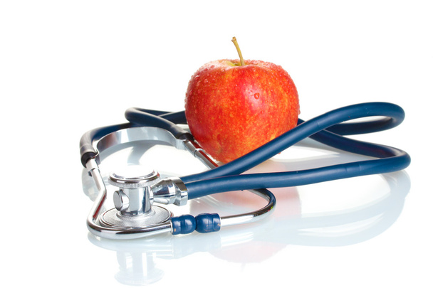 Medical stethoscope and red apple isolated on white - Foto, afbeelding