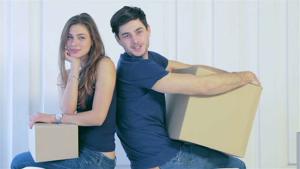 Пара девушек и парень, смотрящие друг на друга между коробками
 - Кадры, видео