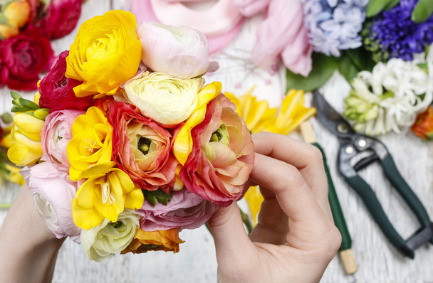 Woman making bouquet of persian buttercup flowers (ranunculus) a - Photo, Image