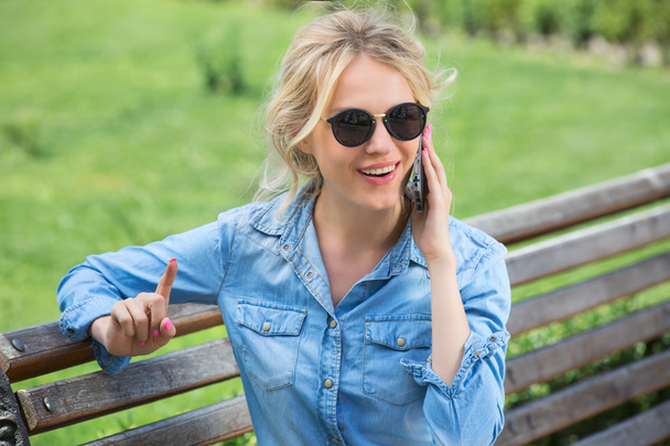 Cute blonde talking on a cell phone. - Фото, изображение