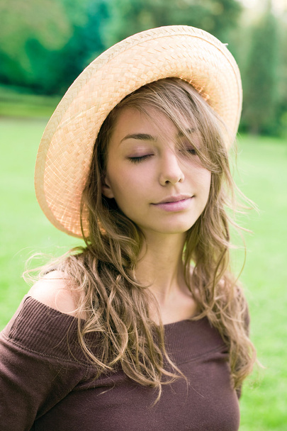 Beautiful relaxed young spring brunette outdoors in nature. - Photo, image
