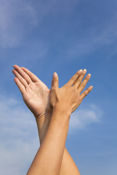 Bird hand gesture in the blue sky - Foto, afbeelding