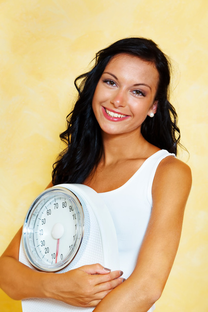 Woman with scales after a successful diet - Foto, imagen