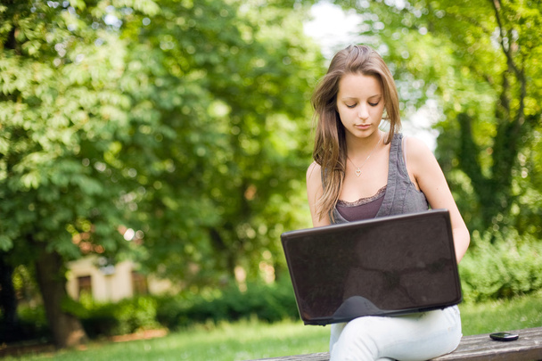 Outdoors with her laptop. - Фото, изображение