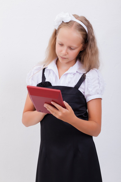 Portrait of teen girl with calculator on white background - Fotó, kép