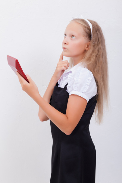 Portrait of teen girl with calculator on white background - Foto, imagen