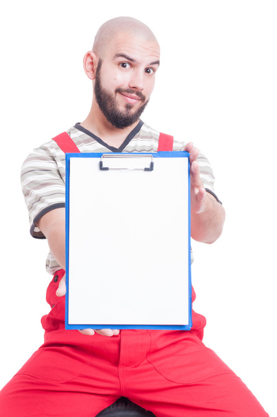 Mechanic holding a clipboard with blank page - Zdjęcie, obraz