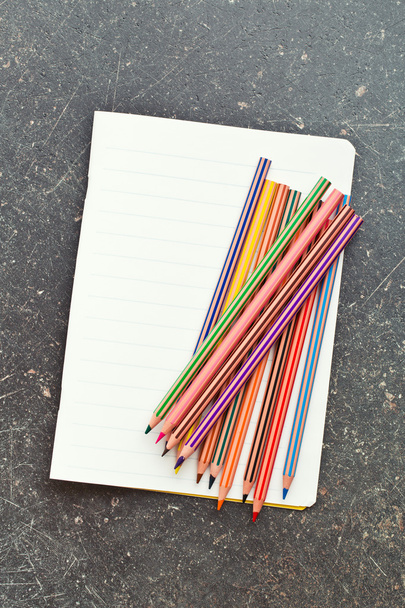 colour pencils and blank workbook - Foto, Imagem