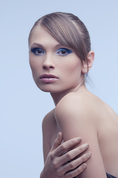 Beautiful women with perfect skin, bright trendy makeup on a blue backgroun - Photo, image