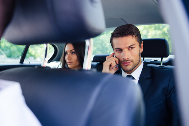 Biznesmen rozmawia przez telefon w samochodzie - Zdjęcie, obraz