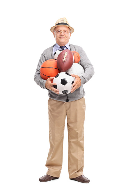 Senior gentleman holding sports balls - Foto, Bild