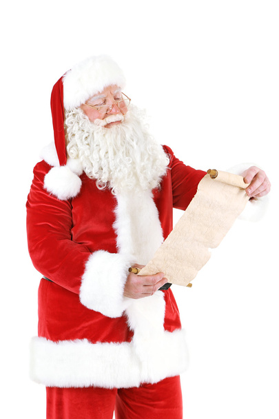 Santa Claus holding wish list - Foto, Imagen