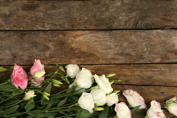 Beautiful eustoma on wooden background - Photo, Image