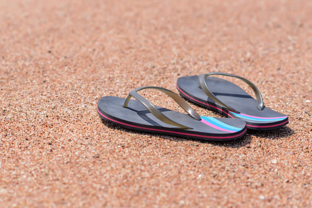 Pair of Flip Flops on Sandy Beach Shore - Foto, afbeelding