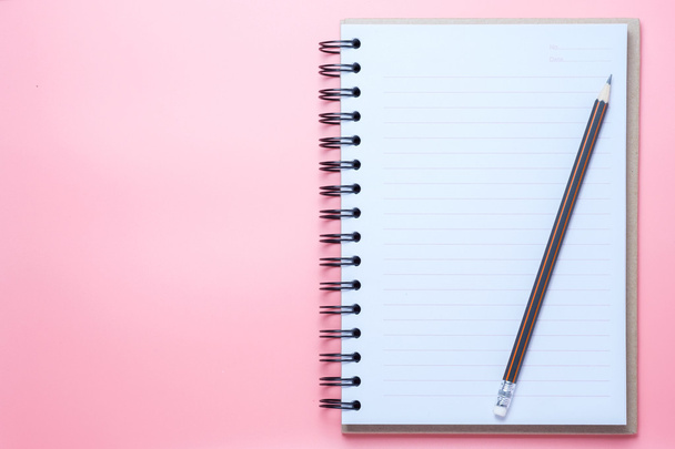Notebook and pencil on pink background - Foto, Imagen