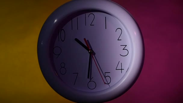 Clock on color wooden plank wall, night Light. slow motion - Footage, Video