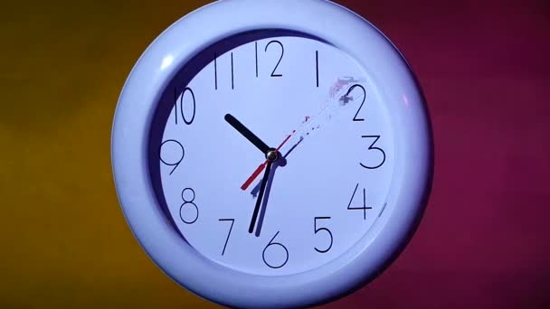 white clock on colorful background. slow motion - Footage, Video