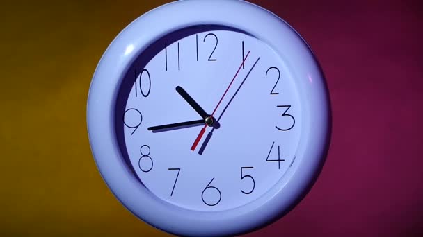 close up of an white clock on colorful background. slow motion - Footage, Video