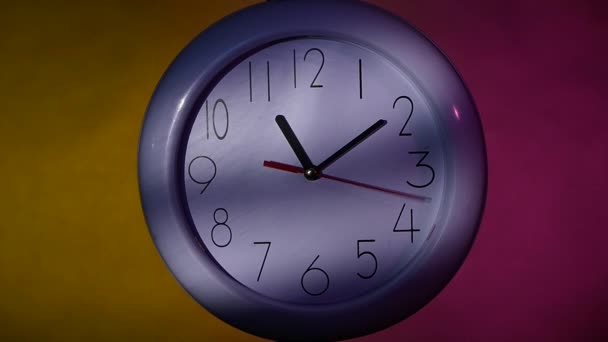 office white clock on colorful background. slow motion - Footage, Video