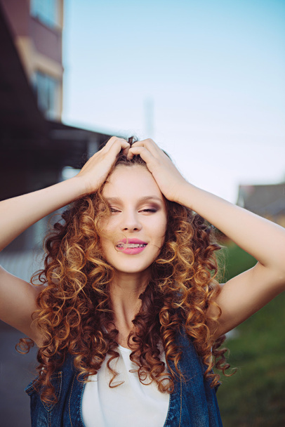 beautiful young girl with curly hair - Фото, зображення