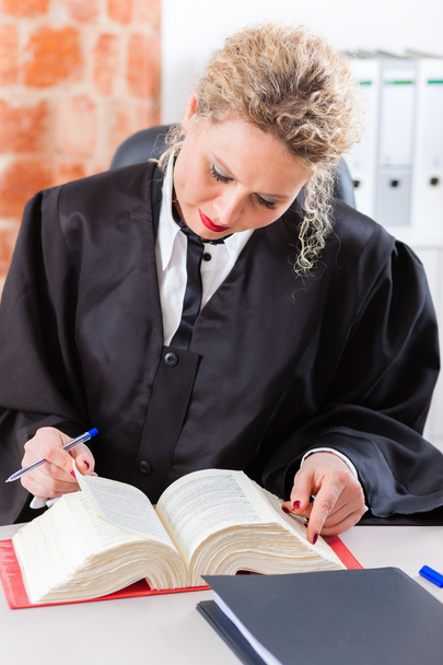 Lawyer in office reading law book - Фото, зображення
