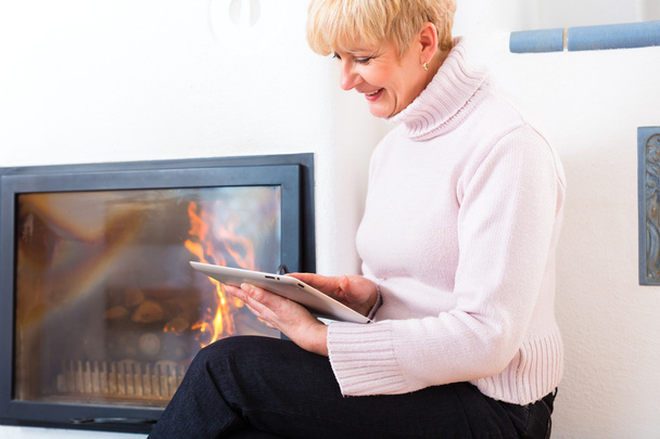 Female Senior at home in front of fireplace - Photo, Image