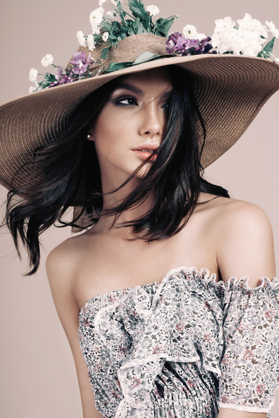 beautiful girl in a hat with flowers - Фото, изображение