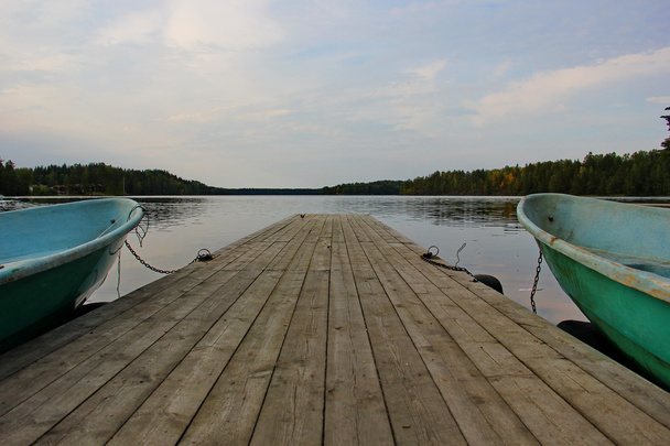a smooth lake, pier, boat - Foto, imagen