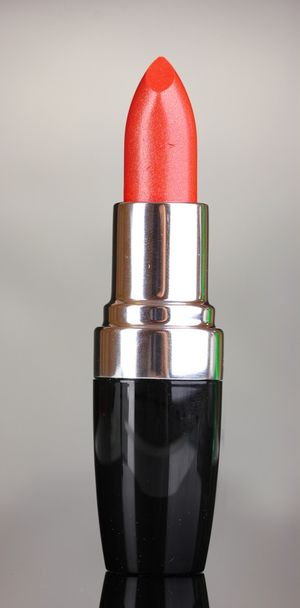 Beautiful lipstick on gray background - Фото, зображення