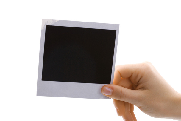 Photo paper in hand isolated on white - Foto, afbeelding