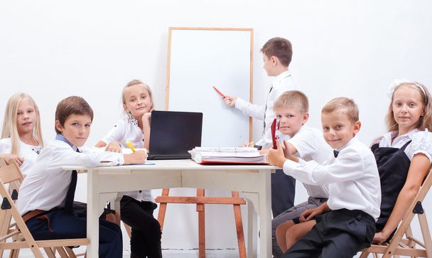 The group of teenagers sitting in a business meeting - Photo, Image
