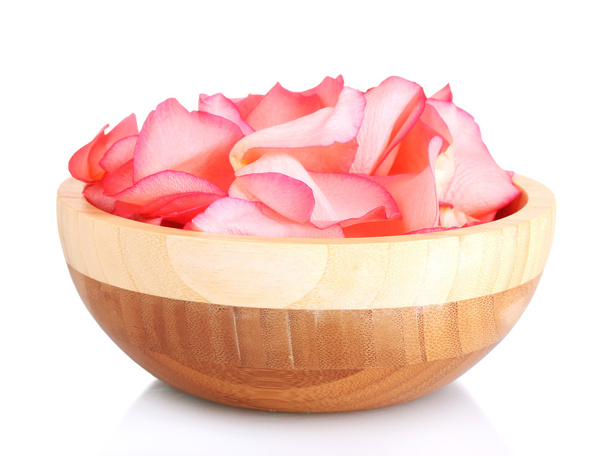 Beautiful pink rose petals on wooden bowl isolated on white - 写真・画像