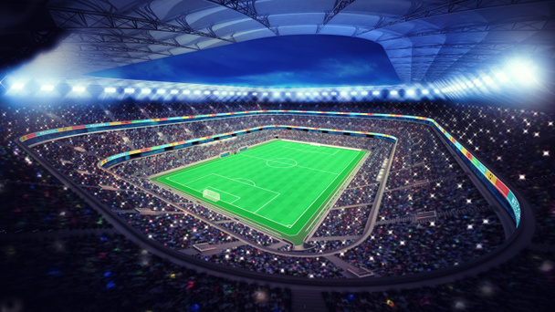 освещенный футбольный стадион с болельщиками на трибунах
 - Фото, изображение