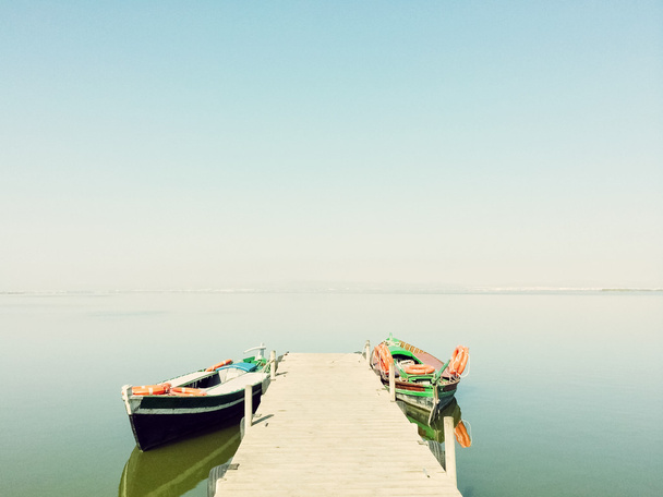 Calm lake with two fishing boats - Photo, Image