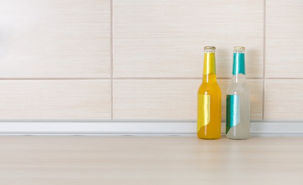 Bottles of drink on kitchen countertop - Photo, image