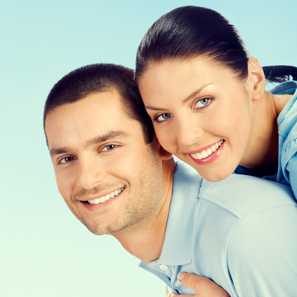 Cheerful young couple, over blue  - Photo, Image